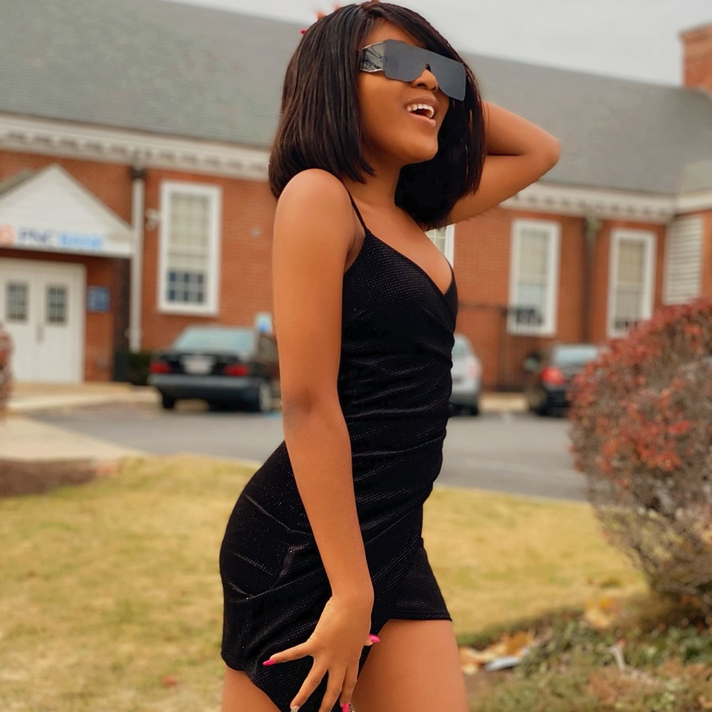 A mini black dress with silver shine